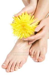 womans-foot-and-hand-with-flowers-on-white-1